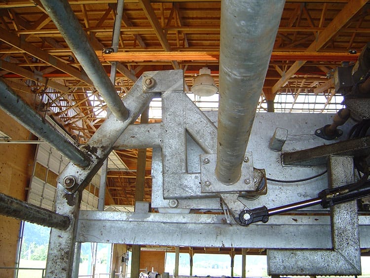 Close up of the hydraulic components of a dairy crowd gate