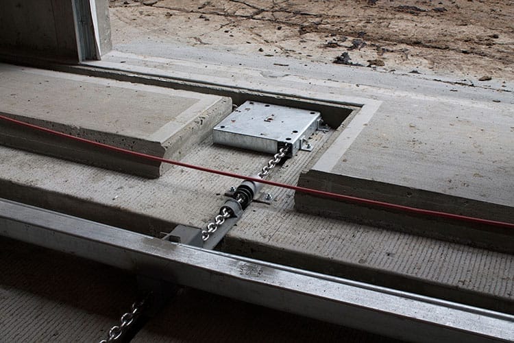 Close up of chain driven cow manure scraper